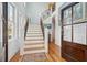 Bright foyer with a staircase, hardwood floors, wainscoting, and decorative artwork at 3 37Th Ave, Isle of Palms, SC 29451
