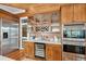 Butler pantry with wine storage, glass cabinets, marble countertop, and stainless appliances at 3 37Th Ave, Isle of Palms, SC 29451