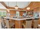 Wooden kitchen with bar seating, modern appliances, marble countertops, and designer lighting at 3 37Th Ave, Isle of Palms, SC 29451
