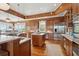 Wood-paneled kitchen with island and stainless appliances; bright, spacious and modern design elements at 3 37Th Ave, Isle of Palms, SC 29451