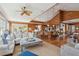 Spacious living room featuring wood paneling, high ceilings, a dining area, and a modern kitchen at 3 37Th Ave, Isle of Palms, SC 29451