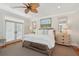 This main bedroom boasts neutral decor, a ceiling fan, french doors to the backyard, and ample natural light at 3 37Th Ave, Isle of Palms, SC 29451