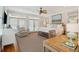 This main bedroom features a ceiling fan, wood-framed bed, white bedding, french doors, and natural light at 3 37Th Ave, Isle of Palms, SC 29451