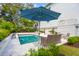 Backyard pool with lounge seating, and a blue umbrella for sun protection at 3 37Th Ave, Isle of Palms, SC 29451