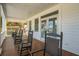 Exterior porch featuring rocking chairs, wood floors, wood ceiling, white trim, and multiple sets of french doors at 3 37Th Ave, Isle of Palms, SC 29451