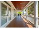 Back porch featuring multiple sets of french doors, wood floors, wood ceiling, and neighborhood views at 3 37Th Ave, Isle of Palms, SC 29451
