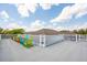Expansive rooftop deck furnished with colorful Adirondack chairs against a clear blue sky at 3 37Th Ave, Isle of Palms, SC 29451