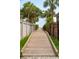 Wooden walkway leading to the beach, framed by lush greenery and decorative fencing at 3 37Th Ave, Isle of Palms, SC 29451