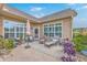 Serene backyard patio with stylish seating, plants, and a view of the manicured lawn at 301 Blakely Village Ln, Summerville, SC 29486