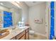 Well-lit bathroom features a vanity, toilet, decorative towels, and tiled floors at 301 Blakely Village Ln, Summerville, SC 29486
