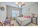 Cozy bedroom features a decorative bed, accent chairs, ceiling fan, and natural light at 301 Blakely Village Ln, Summerville, SC 29486