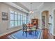 Bright dining area with elegant chandelier, shutters, and hardwood floors at 301 Blakely Village Ln, Summerville, SC 29486