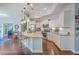Modern kitchen with stainless steel appliances, granite countertops, a center island with bar seating, and hardwood floors at 301 Blakely Village Ln, Summerville, SC 29486
