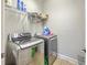 Modern laundry room with front-load washer/dryer and storage shelves at 301 Blakely Village Ln, Summerville, SC 29486
