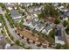 Aerial view of a neighborhood with well-maintained houses, mature trees, and neatly lined streets at 308 Scholar Way, Summerville, SC 29486
