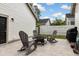 Backyard patio featuring a fire pit, rocking chairs, gray pavers, and white siding at 308 Scholar Way, Summerville, SC 29486