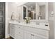 Elegant bathroom featuring double sinks, white cabinets and a framed mirror at 308 Scholar Way, Summerville, SC 29486