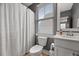 Cozy bathroom with a grey vanity, white shower curtain and natural light at 308 Scholar Way, Summerville, SC 29486