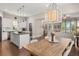 Open kitchen and dining area featuring an island, stainless steel appliances and hardwood floors at 308 Scholar Way, Summerville, SC 29486