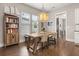 Charming dining room with a rustic table, decorative lighting, and ample natural light at 308 Scholar Way, Summerville, SC 29486