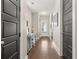Bright hallway leading to rooms with beautiful hardwood floors and neutral-toned walls at 308 Scholar Way, Summerville, SC 29486