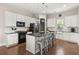 Modern kitchen with white cabinets, stainless steel appliances, and a spacious center island at 308 Scholar Way, Summerville, SC 29486