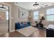 Bright room featuring a blue couch, modern artwork and a workout bike at 308 Scholar Way, Summerville, SC 29486