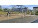 Community playground with a modern jungle gym, climbing ropes, and soft landing surface at 308 Scholar Way, Summerville, SC 29486