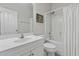 Well-lit bathroom with a white vanity, toilet, and shower/tub with neutral colored walls at 311 Amaryllis Ave, Summerville, SC 29483