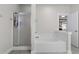 Clean bathroom showcasing a glass-enclosed shower and a separate soaking tub at 311 Amaryllis Ave, Summerville, SC 29483