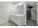 Bright bathroom with double vanity, large mirror, and a spacious walk-in closet at 311 Amaryllis Ave, Summerville, SC 29483