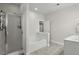 Well-lit bathroom featuring a glass-enclosed shower and a separate soaking tub at 311 Amaryllis Ave, Summerville, SC 29483