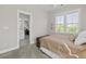 Comfortable bedroom with a queen bed, carpeted floors, and a door that leads to the Primary bath at 311 Amaryllis Ave, Summerville, SC 29483