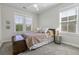 Cozy bedroom with a queen bed, wood accents, two large windows with blinds, and a ceiling fan at 311 Amaryllis Ave, Summerville, SC 29483