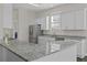 Lovely kitchen features granite countertops, stainless steel appliances and white cabinets at 311 Amaryllis Ave, Summerville, SC 29483