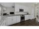 Open kitchen boasts stainless steel appliances, granite countertops and white cabinets at 311 Amaryllis Ave, Summerville, SC 29483