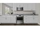 Lovely kitchen features stainless steel appliances, granite countertops and white cabinets at 311 Amaryllis Ave, Summerville, SC 29483