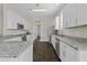 Modern kitchen featuring stainless steel appliances, granite countertops and white cabinets at 311 Amaryllis Ave, Summerville, SC 29483