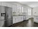 Bright kitchen showcases stainless steel appliances, granite countertops and white cabinets at 311 Amaryllis Ave, Summerville, SC 29483