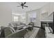 Open living room area featuring fireplace, ceiling fan, and ample seating at 311 Amaryllis Ave, Summerville, SC 29483
