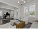 Bright living room with ample seating, hardwood floors, and a grand piano in the background at 311 Amaryllis Ave, Summerville, SC 29483