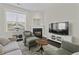 Comfortable living room with a fireplace, plush seating, TV, and bright natural light at 311 Amaryllis Ave, Summerville, SC 29483