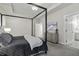 Tastefully designed main bedroom with elegant four-post bed and calming neutral color palette at 311 Amaryllis Ave, Summerville, SC 29483