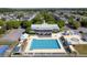 Resort-style pool with many lounge chairs and splash pad surrounded by a clubhouse and residential neighborhood at 311 Amaryllis Ave, Summerville, SC 29483