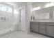 Luxurious bathroom featuring a glass enclosed shower, marble floors, and gray cabinets at 3130 Sturbridge Rd, Mount Pleasant, SC 29466