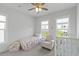 Charming bedroom with plenty of natural light from two windows and comfortable seating at 3130 Sturbridge Rd, Mount Pleasant, SC 29466