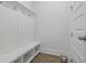 Bright mudroom boasts a built-in bench, shelving and coat hooks for optimal organization and style at 3130 Sturbridge Rd, Mount Pleasant, SC 29466