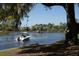 Scenic water view showcasing a motorboat along the shores and waterfront homes in the distance at 3130 Sturbridge Rd, Mount Pleasant, SC 29466