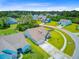 Aerial view of a charming neighborhood with colorful homes and lush greenery under a bright blue sky at 3154 Hugh Bennett Dr, Johns Island, SC 29455