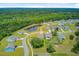 Aerial view of neighborhood with mature trees, pond, and thoughtfully designed landscaping at 3154 Hugh Bennett Dr, Johns Island, SC 29455